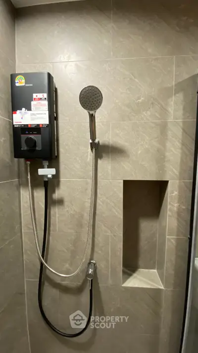 Modern bathroom shower with sleek design and built-in storage niche.