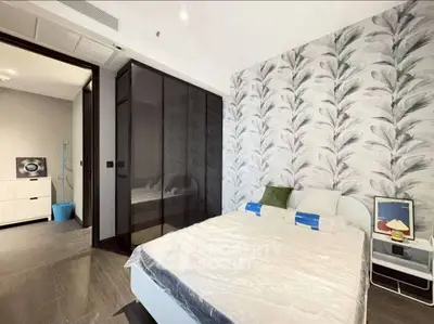 Modern bedroom with stylish wallpaper and sleek wardrobe design