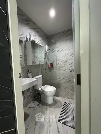 Modern bathroom with marble tiles and sleek fixtures