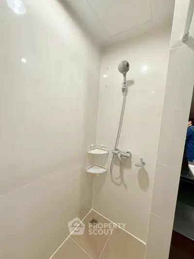 Modern bathroom shower area with sleek tiles and chrome fixtures