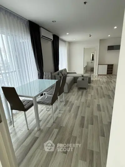 Spacious modern living room with elegant dining area and natural light