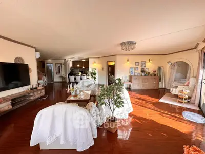 Spacious and sunlit living room with elegant decor and open layout, perfect for modern living.