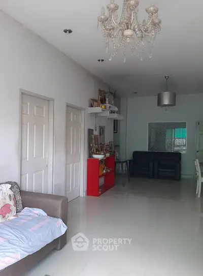 Spacious living room with elegant chandelier and modern decor