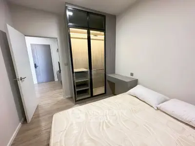 Modern bedroom with sleek wardrobe and cozy bed in stylish apartment