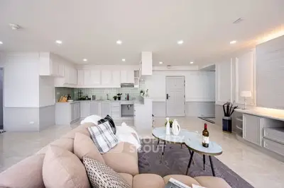 Spacious modern living room with open kitchen layout and elegant decor