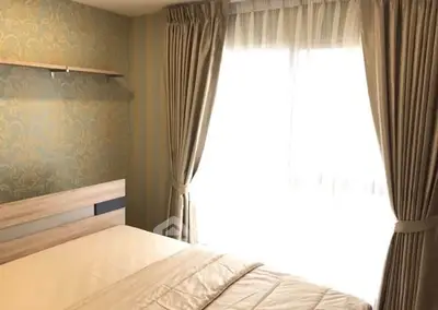 Cozy bedroom with elegant wallpaper and natural light