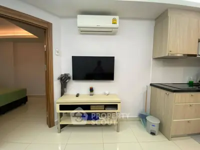 Modern living room with air conditioning and sleek TV setup in stylish apartment.