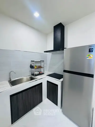 Modern kitchen with sleek appliances and stylish cabinetry in a contemporary home.
