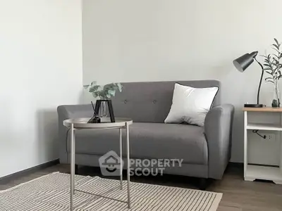 Modern living room with stylish gray sofa and sleek decor