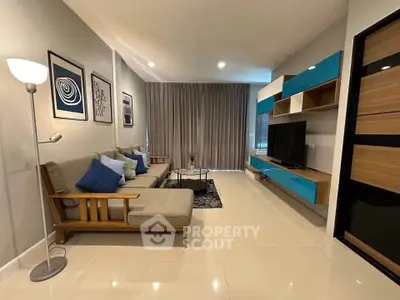 Modern living room with stylish decor and spacious layout, featuring a comfortable sofa and sleek entertainment unit.