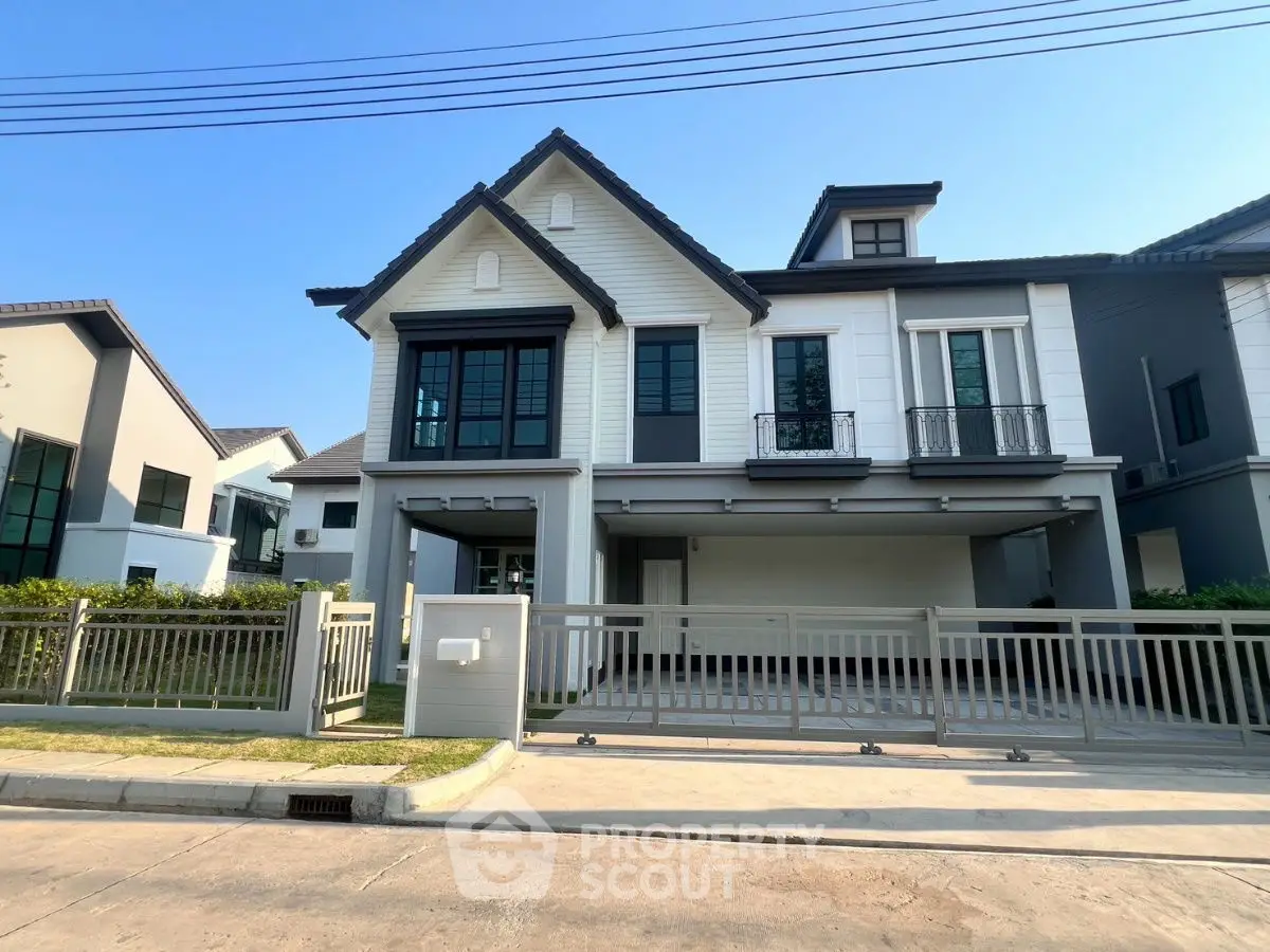 Modern two-story house with stylish facade and spacious driveway in a suburban neighborhood.