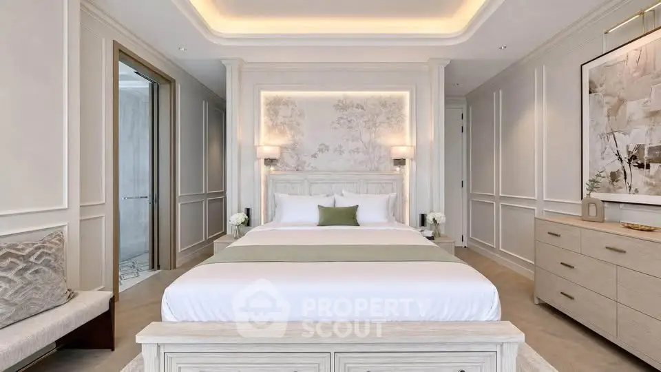 Luxurious bedroom with elegant decor and soft lighting, featuring a comfortable bed and stylish furnishings.