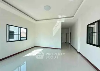 Spacious and bright living room with large windows and modern design.