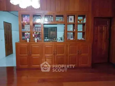 Elegant wooden cabinetry in a cozy living room with warm lighting.