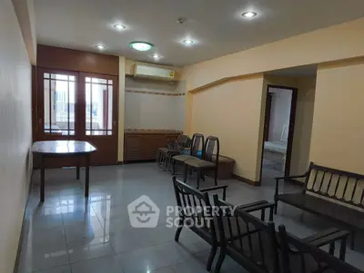 Spacious living room with ample seating and natural light, perfect for family gatherings.
