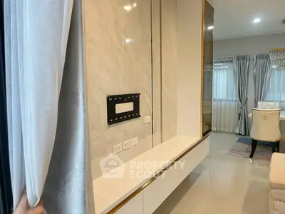 Modern living room with elegant decor and wall-mounted TV setup