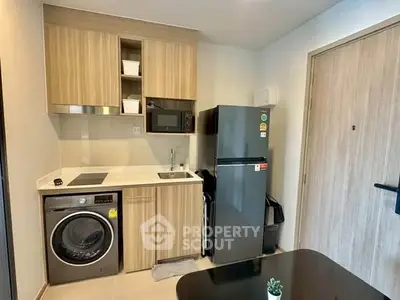 Modern compact kitchen with integrated appliances and sleek wooden cabinetry