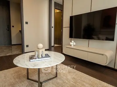 Modern living room with sleek TV setup and stylish coffee table