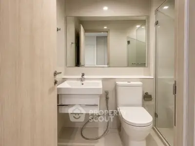 Modern bathroom with sleek fixtures and glass shower enclosure