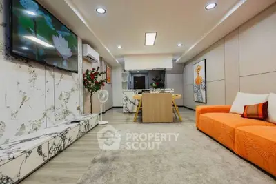 Modern living room with vibrant orange sofa and stylish decor