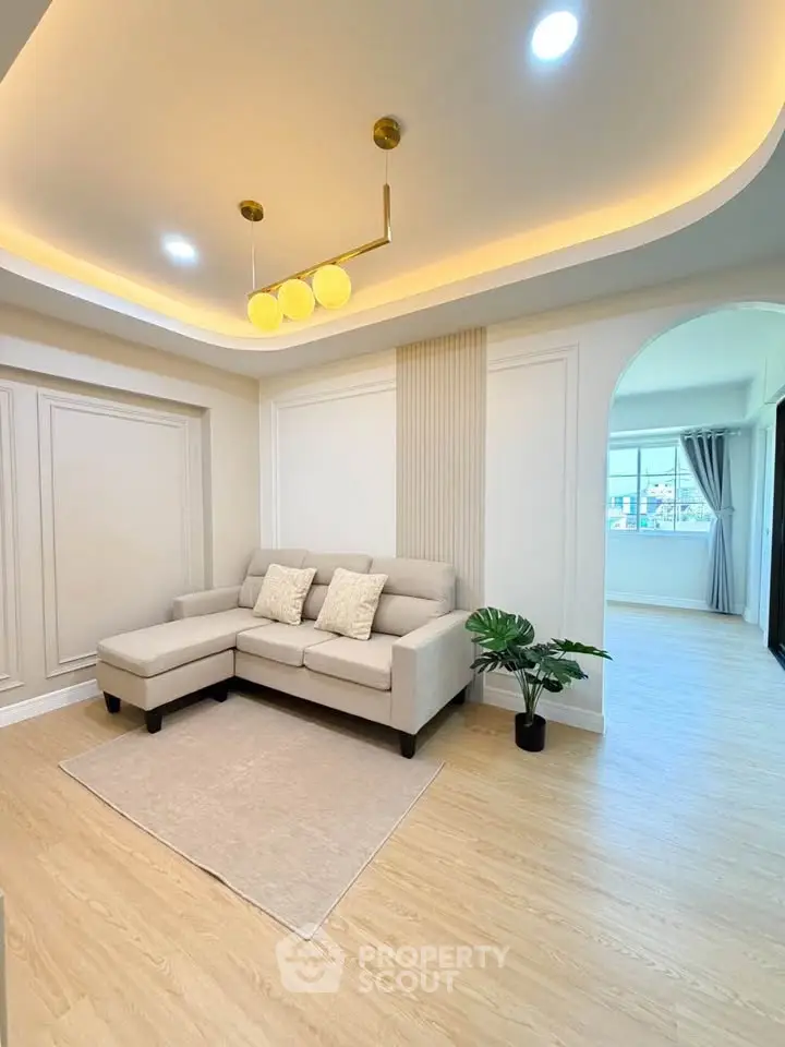 Elegant living room with modern lighting and cozy sofa in a stylish apartment.