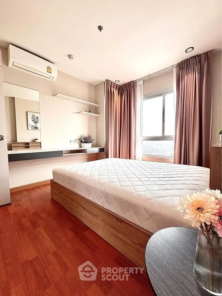 Modern bedroom with large window, wooden flooring, and stylish decor in a high-rise apartment.
