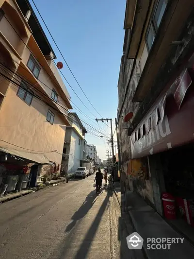 Urban street view with residential buildings and clear blue sky