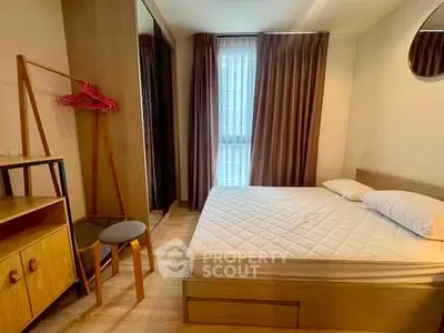 Cozy bedroom with modern furnishings and ample natural light, perfect for relaxation and comfort.