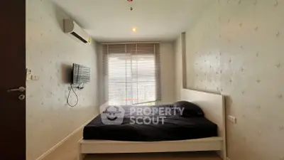 Cozy bedroom with modern decor and natural light from large window