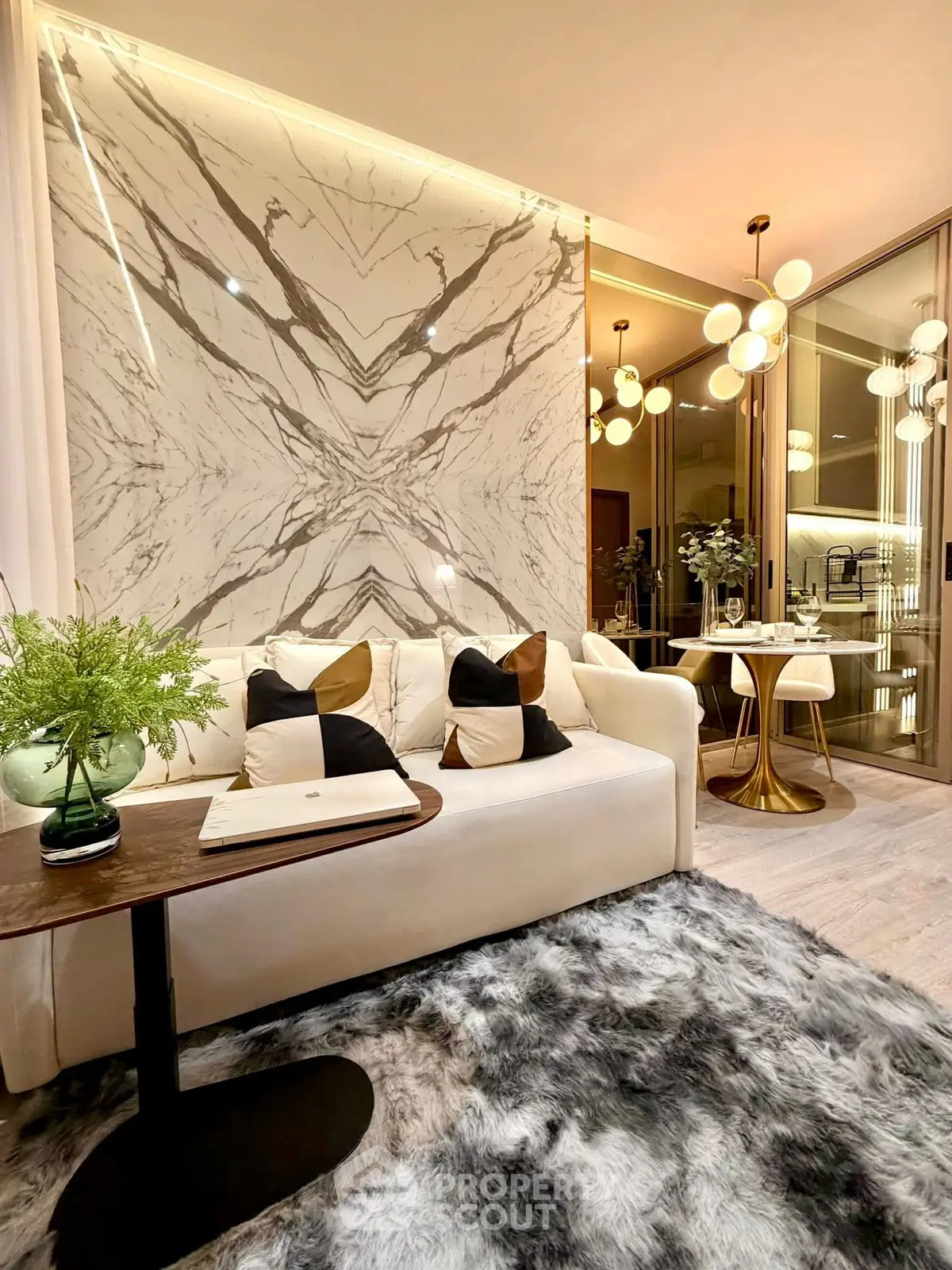 Luxurious modern living room with marble accent wall and elegant decor