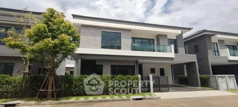 Modern two-story house with sleek design and spacious balcony in a serene neighborhood.