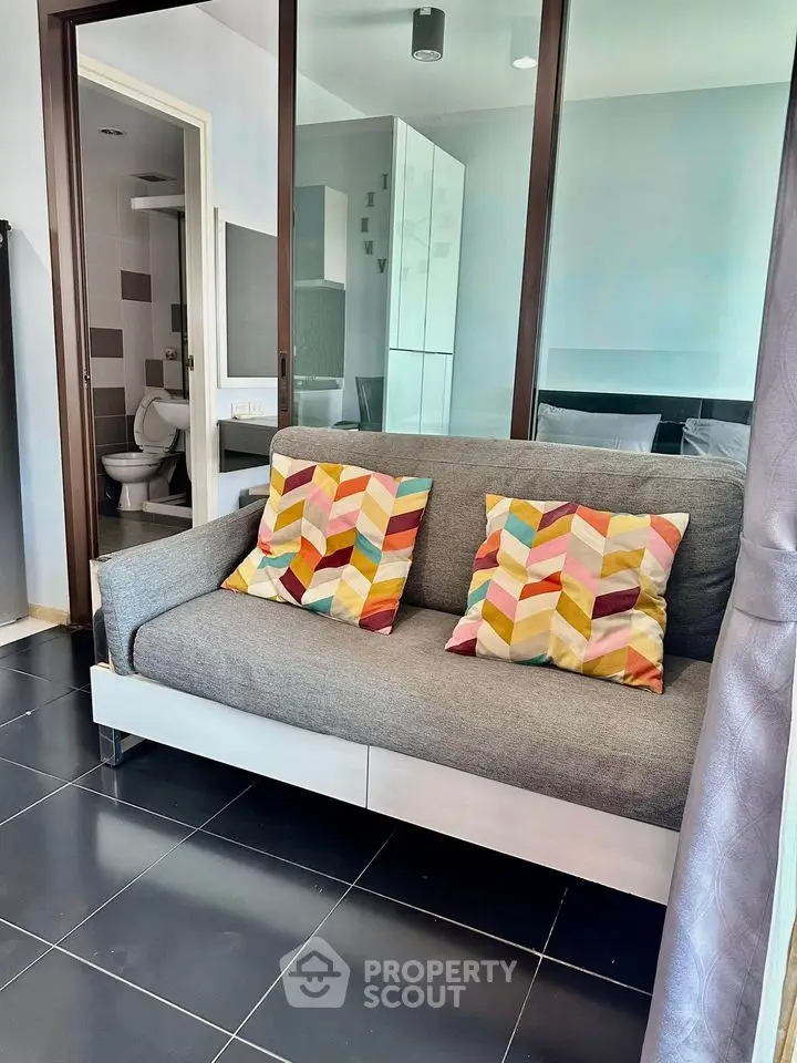 Modern studio apartment with stylish sofa and glass partition