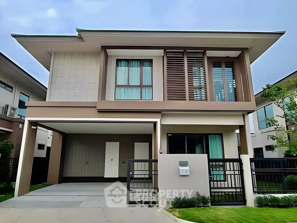 Modern two-story house with sleek design and spacious garage in a serene neighborhood.
