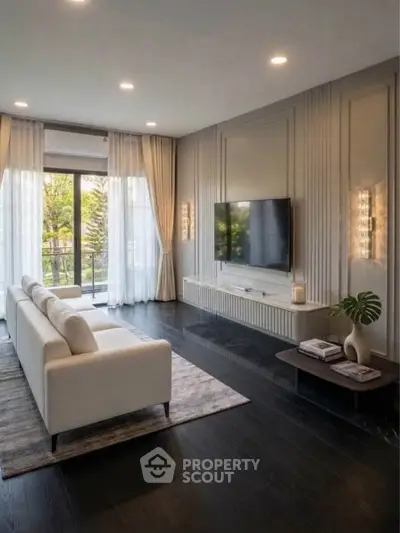 Elegant living room with modern decor and large windows opening to a balcony with a view.