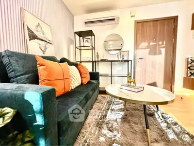 Stylish living room with modern decor, plush sofa, and elegant coffee table.