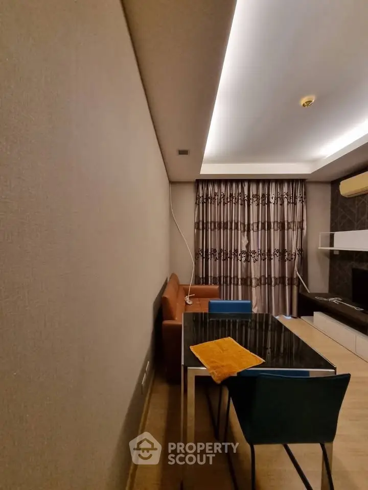 Modern living room with stylish furniture and elegant lighting, perfect for cozy gatherings.