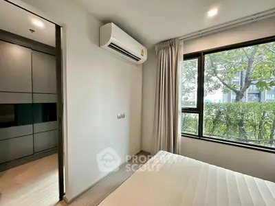 Modern bedroom with large window and air conditioning unit