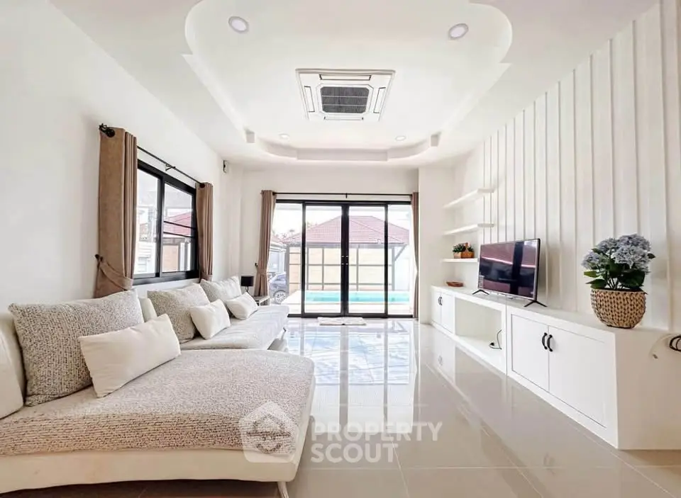 Spacious modern living room with elegant decor and pool view