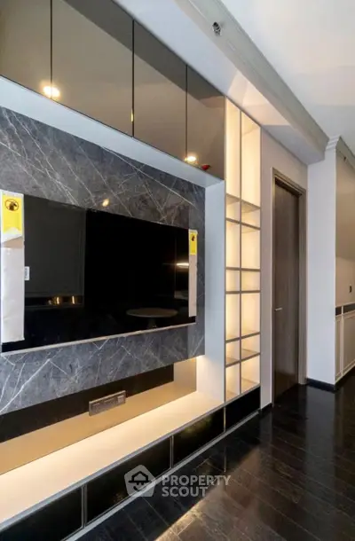 Modern living room with sleek TV wall unit and elegant shelving