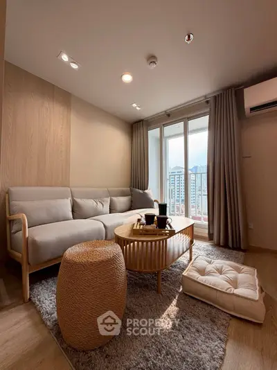 Cozy living room with modern furniture and city view, perfect for relaxation.
