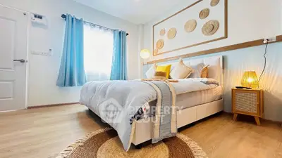Cozy and stylish bedroom with natural light and modern decor, perfect for relaxation and comfort.