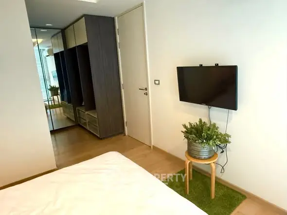 Modern bedroom with wall-mounted TV and stylish decor