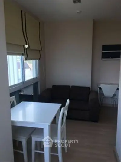 Cozy compact living room with dining area and natural light