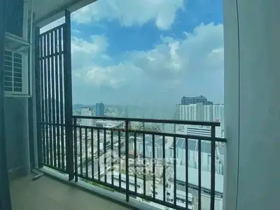 Stunning cityscape view from a high-rise balcony with modern railing.