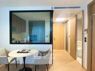Modern apartment interior with dining area and view into kitchen