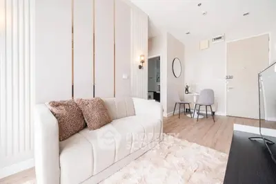 Modern living room with cozy sofa and elegant decor in a stylish apartment.