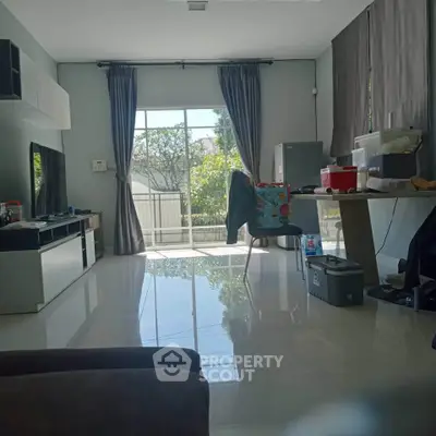 Spacious living room with large windows and modern decor