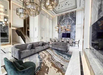 Luxurious modern living room with high ceilings, elegant chandeliers, and stylish decor