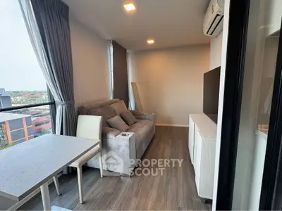 Modern living room with cozy sofa, air conditioning, and large windows offering city views.