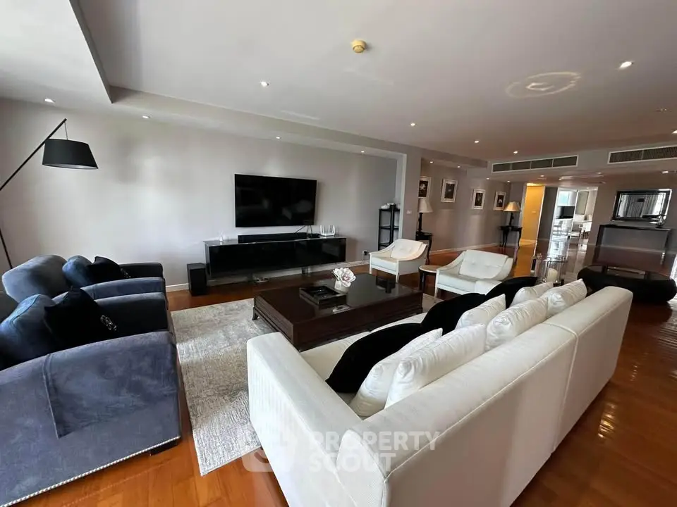 Spacious modern living room with elegant furniture and large TV, perfect for relaxation and entertainment.